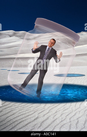 Businessman trapped in glass jar Stock Photo