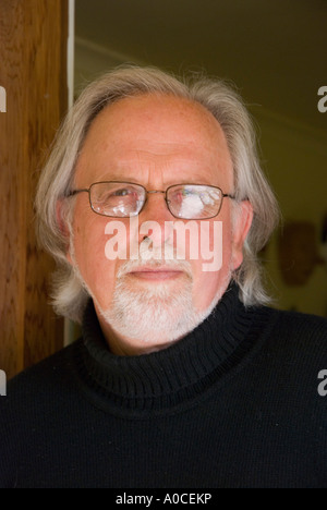 A bearded grey haired older man wearing glasses Stock Photo