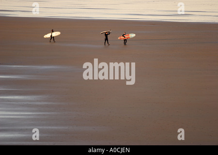 Surfers walking on beach, Tullen Strand, Ireland Stock Photo