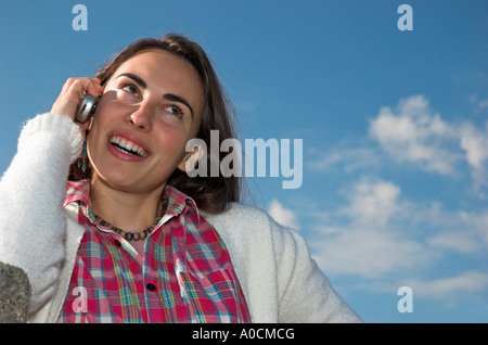 Smiling young woman talking on cell phone Stock Photo
