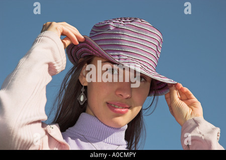 Young woman outdoors wearing hat Stock Photo