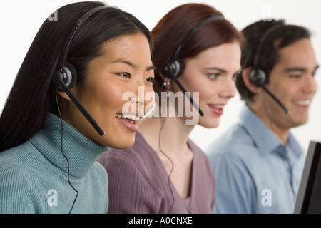 Phone operators using headsets Stock Photo