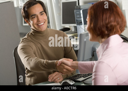 Businessman shaking hands in office Stock Photo