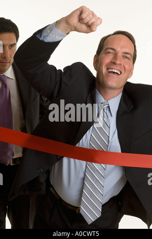 Businessman crossing the finish line Stock Photo