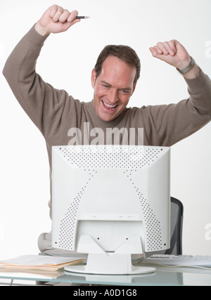 Exuberant man at his computer Stock Photo