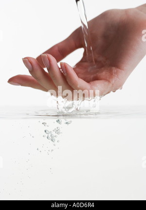 Hand touching water Stock Photo