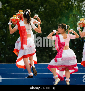 Indian modern dancers in traditional dress at The Mela Gunnersbury Park London UK Stock Photo