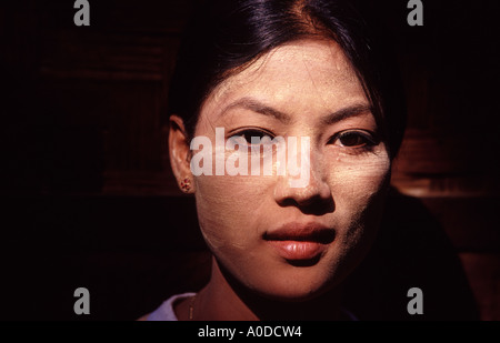 a beautiful young Burmese women wears Tanaka on her face Stock Photo