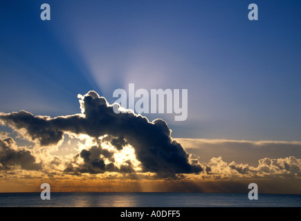 SUNRISE BREAKING THROUGH CLOUDS OVER NORTH SEA ON NORTH NORFOLK COAST, EAST ANGLIA ENGLAND UK Stock Photo