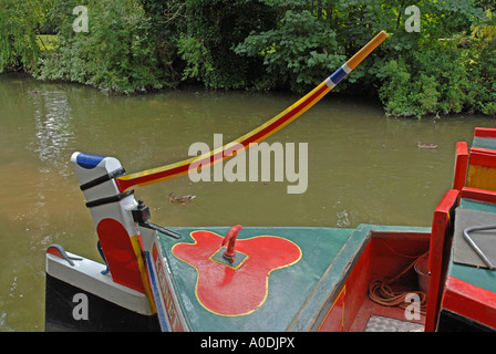 Brightly decorated tiller and stern deck of narrow boat on Kennet & Avon canal, Kintbury, Berkshire, England UK Stock Photo
