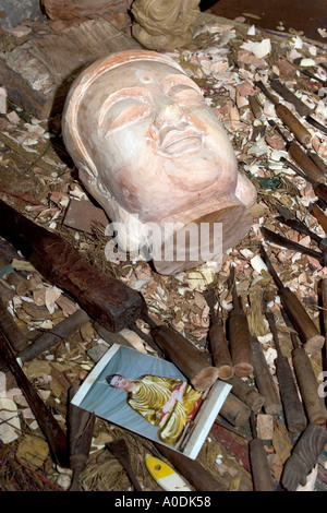 Vietnam Hoi An Old Town Handicraft Workshop crafts carvers chisels with part carved head of buddha in ironwood Stock Photo
