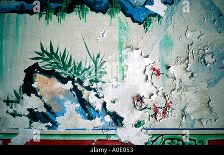 The paint is peeling from an old wall mural Stock Photo