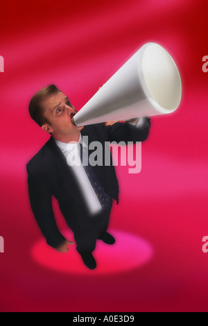 Businessman shouting through megaphone Stock Photo
