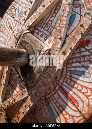 The wooden wheel of a temple car with painted decoration awaits re-use in the next festival at Bhubaneshwar. Stock Photo