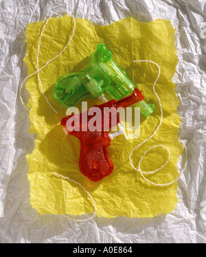 Toy plastic red and green water squirt guns Stock Photo