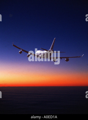 Aircraft Flying Into Sunrise Sunset Stock Photo