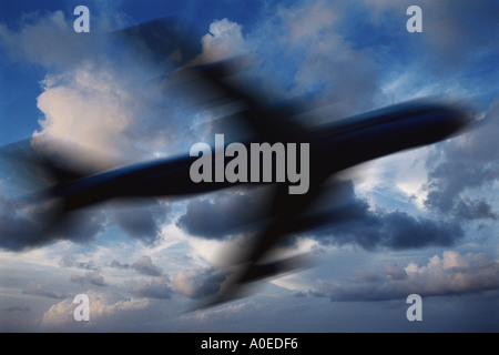 blurred silhouette of plane against sky Stock Photo
