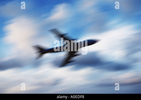 blurred silhouette of plane against sky Stock Photo
