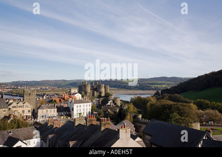 Town rooftops and medieval Castle from walls walk near highest tower with view of Afon River Conwy estuary Conwy North Wales UK Stock Photo