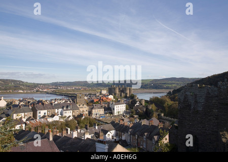 Town rooftops and medieval Castle from walls walk near highest tower with view of Afon River Conwy estuary Conwy North Wales UK Stock Photo