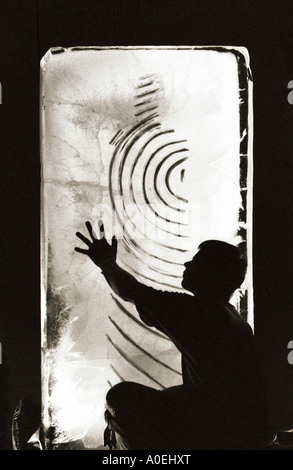 An ice sculptor at work on a piece in Birmingham UK Stock Photo