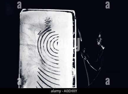 An ice sculptor at work on a piece in Birmingham UK Stock Photo