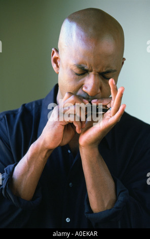 Portrait of man playing harmonica Stock Photo