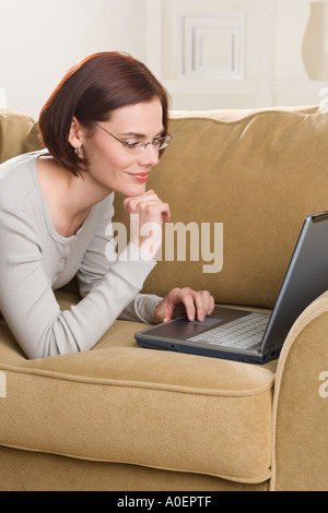 Woman at home using computer Stock Photo