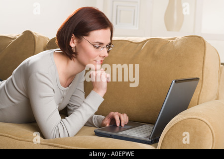 Woman at home using computer Stock Photo