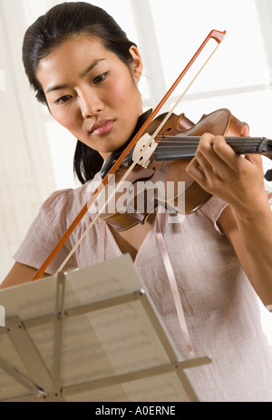 Woman playing violin Stock Photo