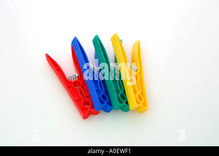 Blue green yellow and red plastic clothes pegs
