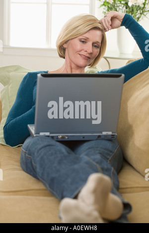 Woman using laptop computer at home Stock Photo