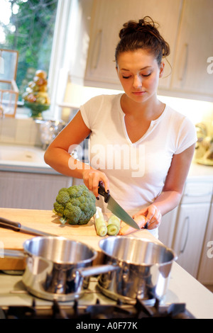 Young woman cooking in kitchen Stock Photo
