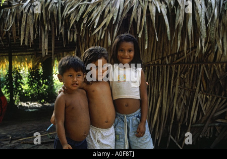 Three tribal children in an Amazon rainforest village Ariau near Manaus Brazil Stock Photo