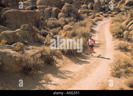 Man running on rural road in the desert Model Released Image Stock Photo