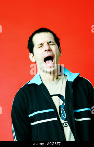 Young man yawning Stock Photo