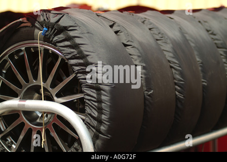 race car tyres slicks in tyre warmer warming blanket heat traction grip  friction rubber wear light weight race racing car sport Stock Photo - Alamy