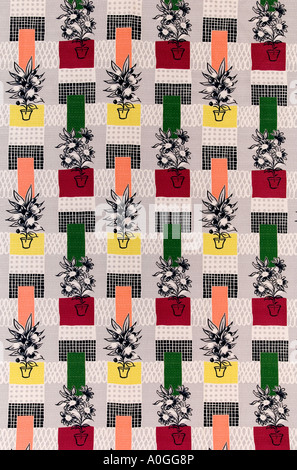 Mad 60s fabric depicting pot plants on a background of red, green, pink, and yellow geometric shapes Stock Photo
