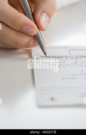 Closeup of hand writing prescription Stock Photo