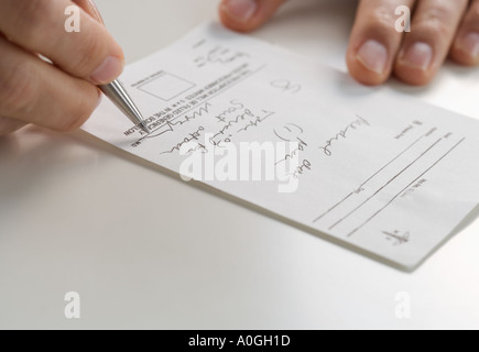 Closeup of hands signing prescription Stock Photo