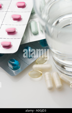 Many pills in packages with water Stock Photo