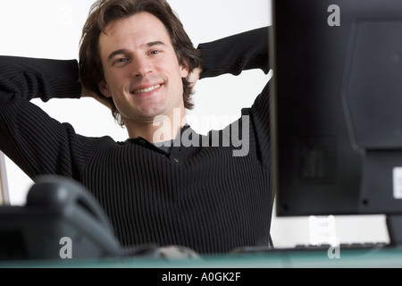 Smiling man at desk with computer Stock Photo
