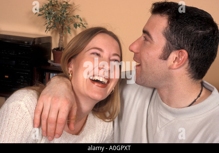 Portrait young happy couple in their 20's laughing together Stock Photo