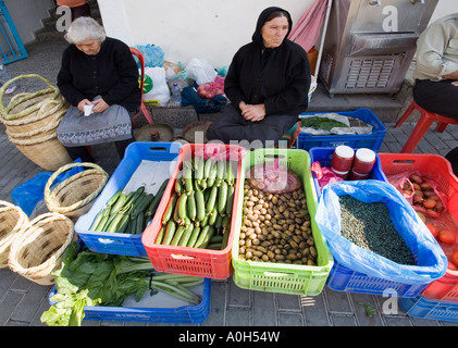 LOCAL WOMEN DRESSED IN TRADITIONAL BLACK CLOTHES WAIT FOR CUSTOMERS AT THE OLD MARKET IN PAPHOS, CYPRUS Stock Photo