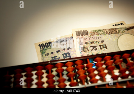 Wooden Japanese abacus and yen. Stock Photo
