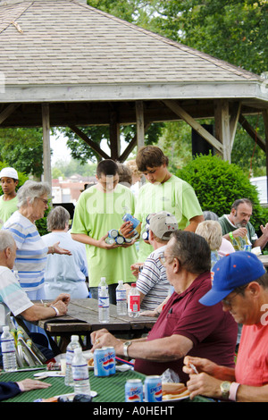 Teenage males providing help at a Seniors July 4th picnic Stock Photo