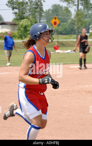 Teenage girl playing in a major league Softball game Stock Photo
