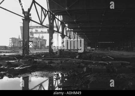 Looking out across the Belfast shipyard from a disused factory Stock Photo