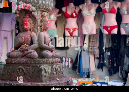 Hindu statue outside shop selling ladies underwear Stock Photo - Alamy