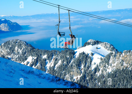 On the ski lift above the clouds over Lake Leman, Alps Vaudoises, Switzerland Stock Photo